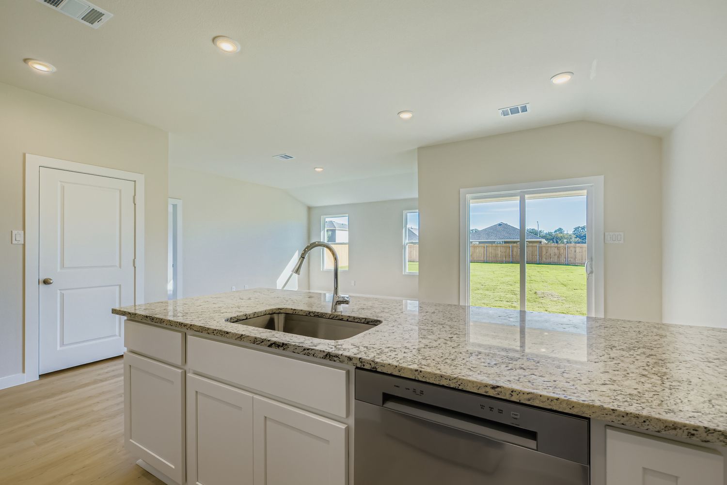 A kitchen with marble counters.