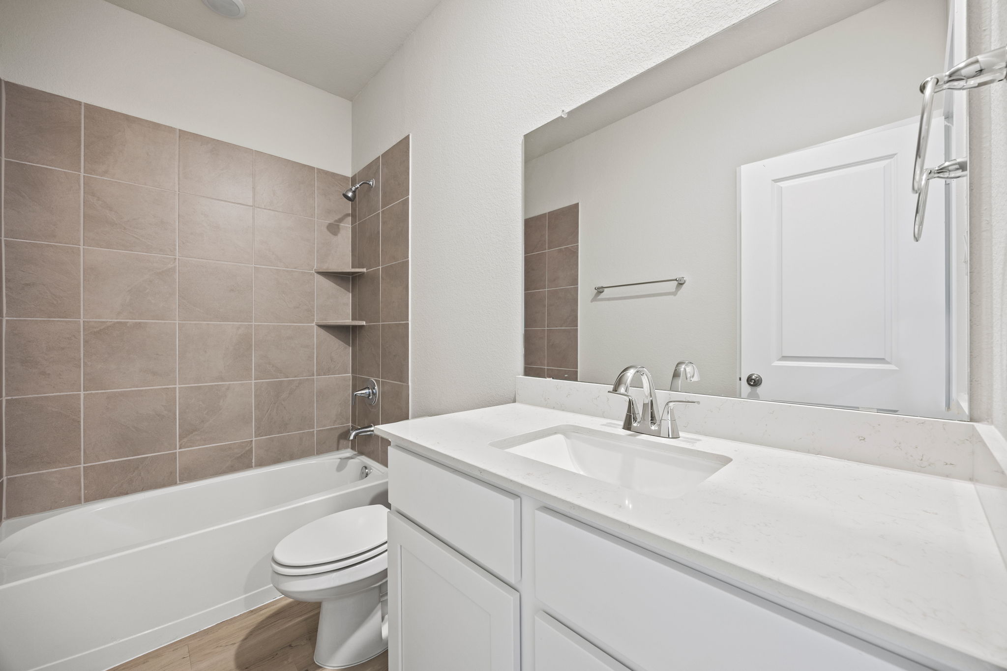 A bathroom with a tub sink and toilet.