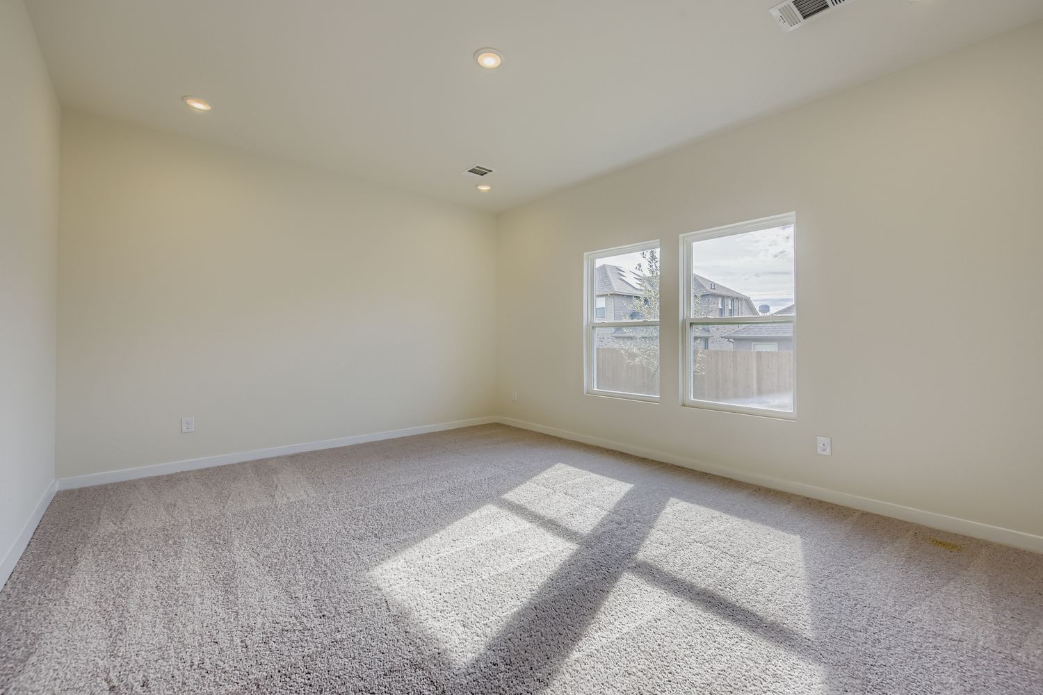 A room with a window and a rug.