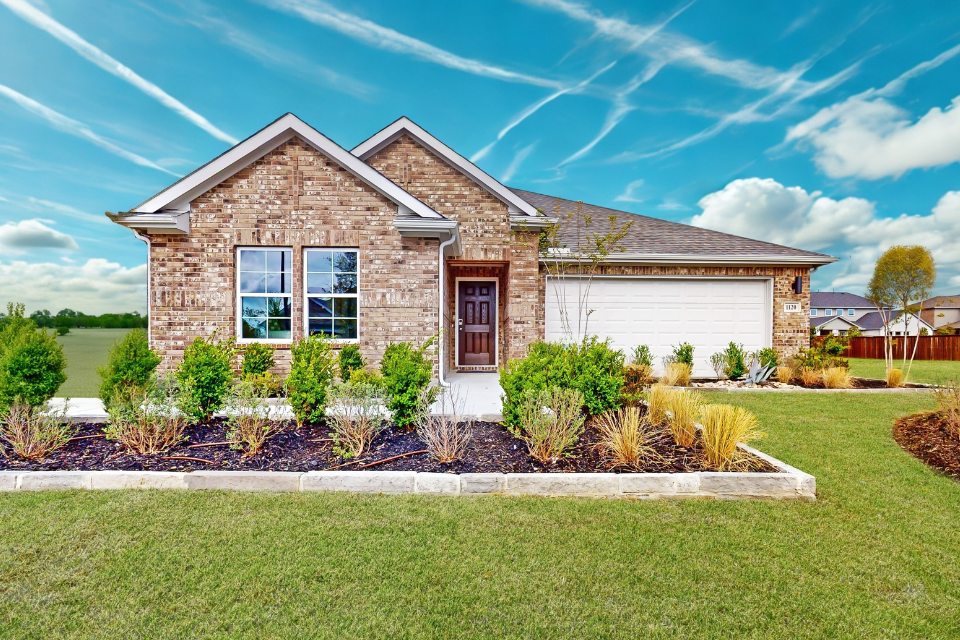 A house with a garage and a lawn.