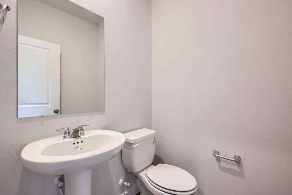 A bathroom with a toilet and sink.