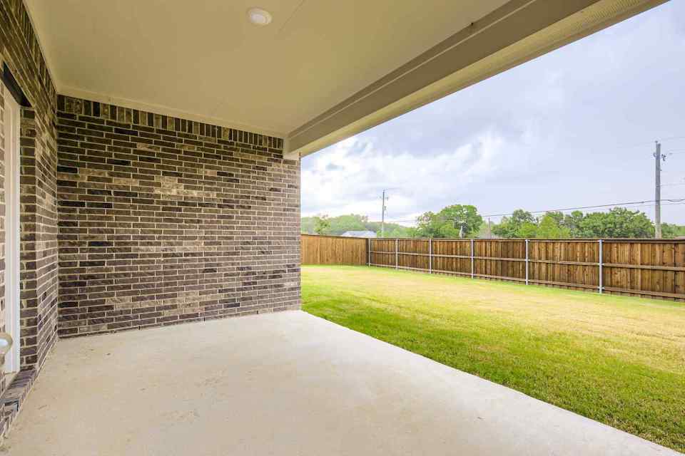 A walkway between brick walls.