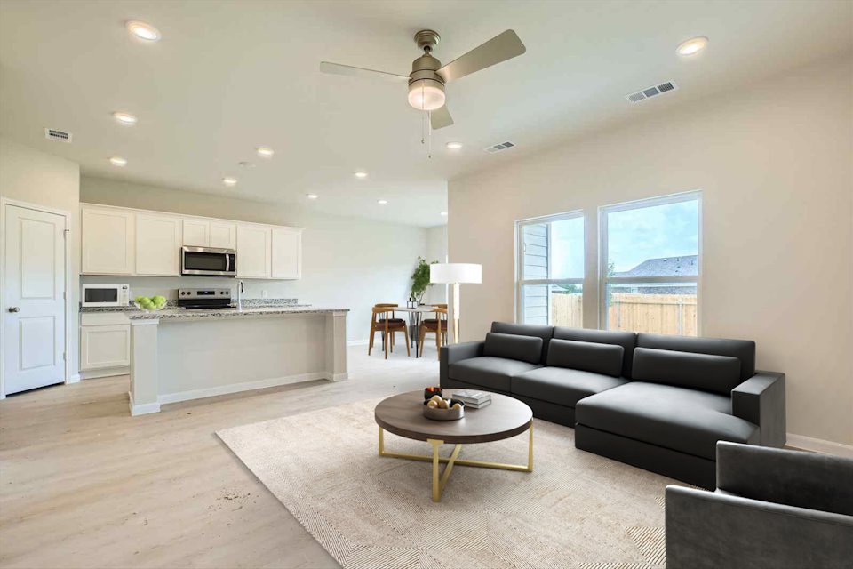 A large living room with a large window.