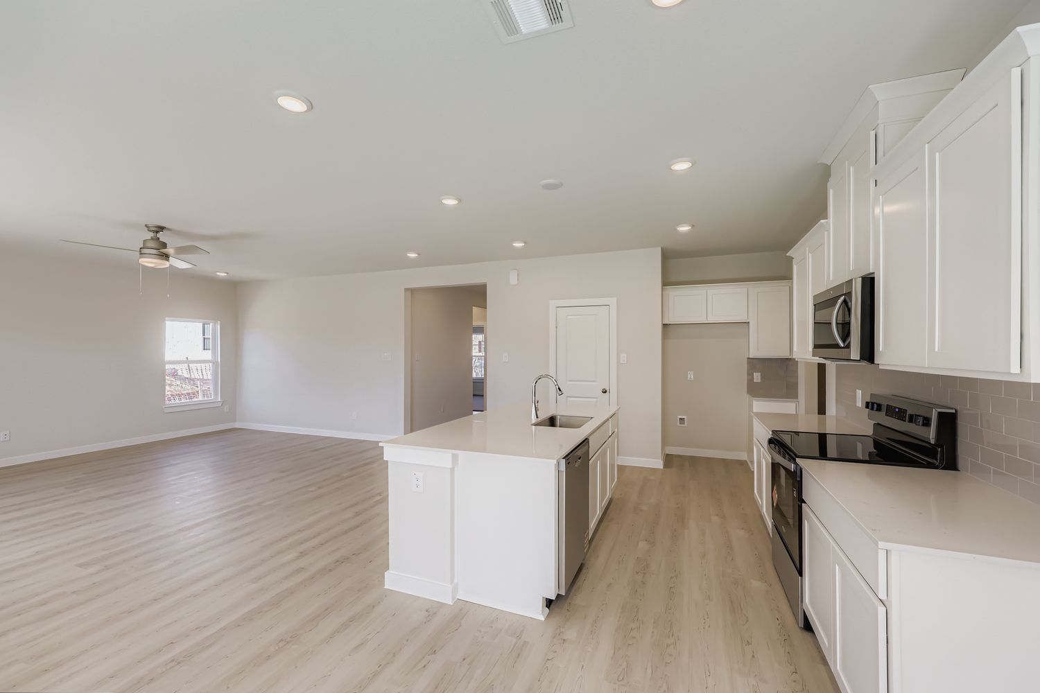 A kitchen with white cabinets.