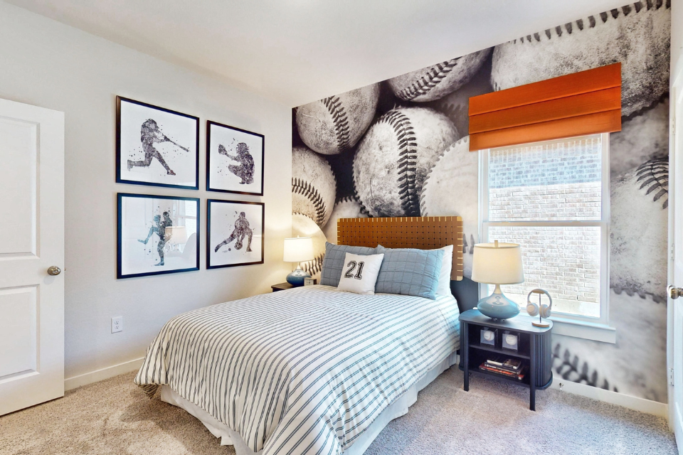 A bedroom with a bed and a table.