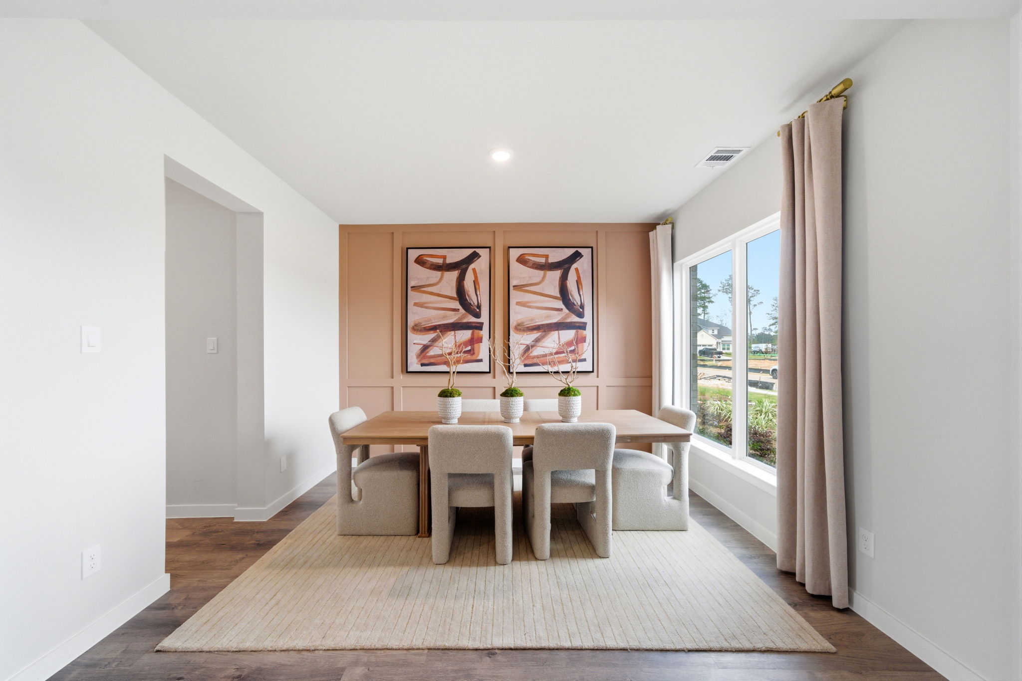 A dining room with a table and chairs.