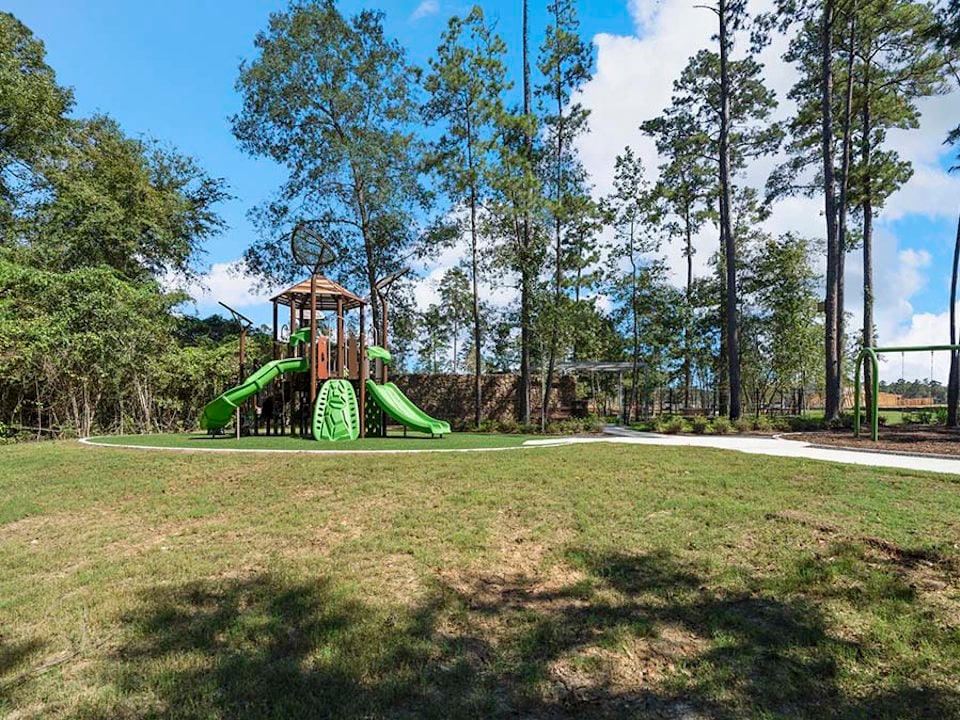 A large green slide in a park.