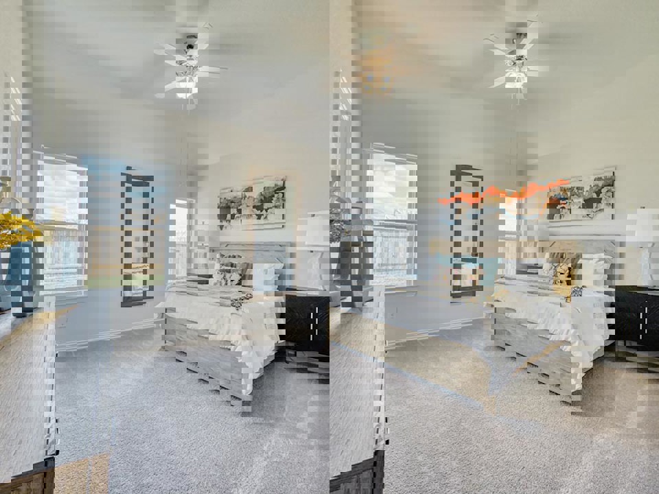 A bedroom with a bed and a fan.