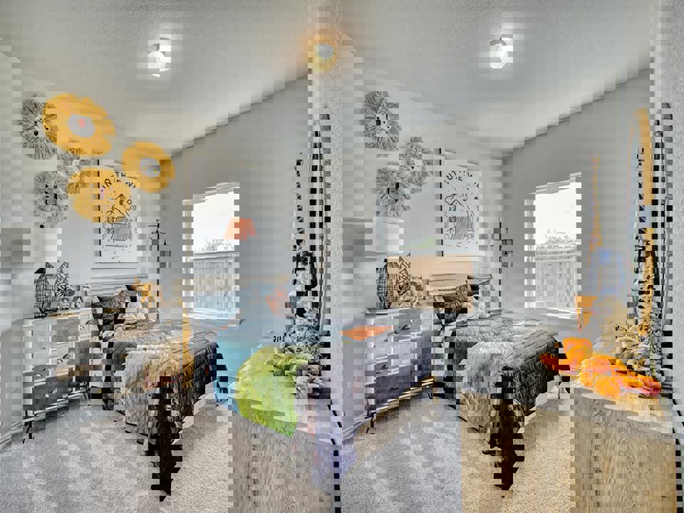 A bedroom with a bed and a table.