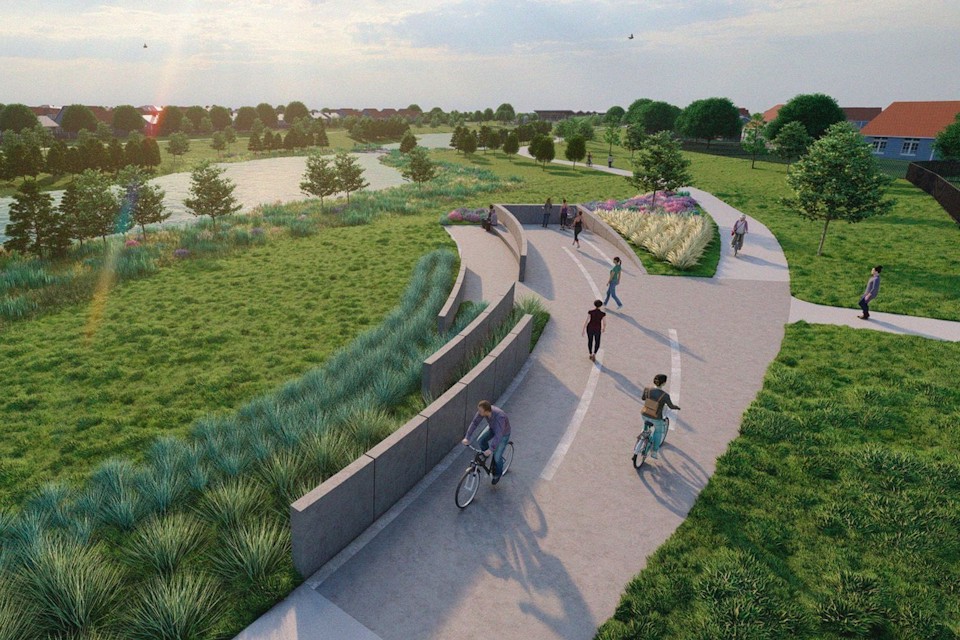 A group of people riding bikes on a path in a park.