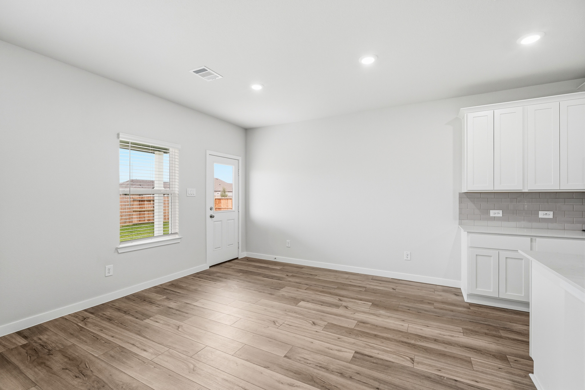 A room with white cabinets.