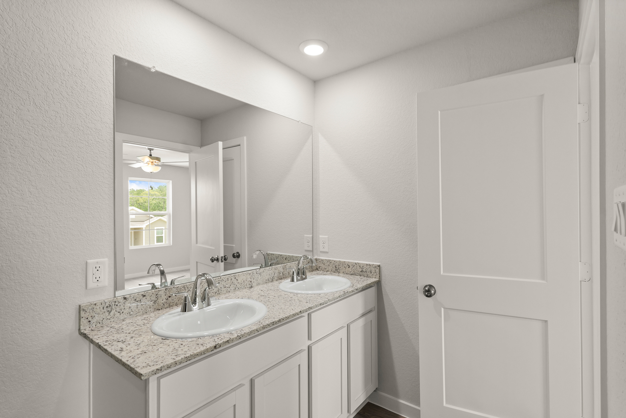 A bathroom with a marble countertop.