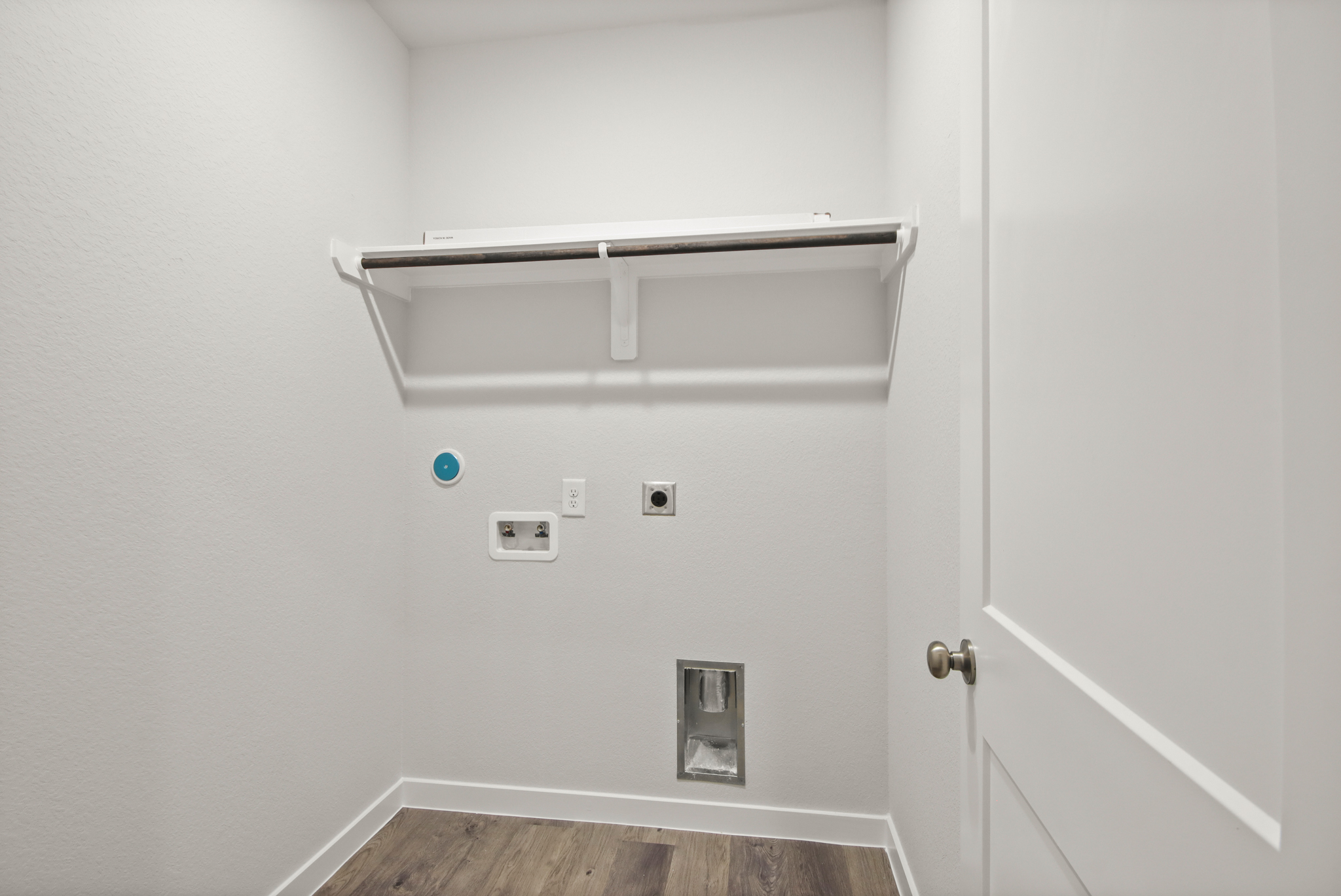 A white wall with a light fixture.