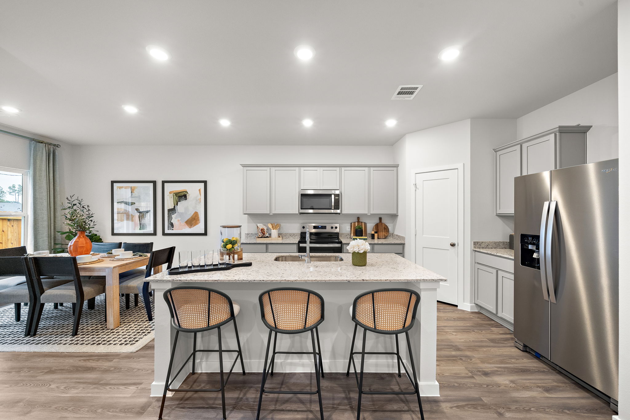 A kitchen with a table and chairs.