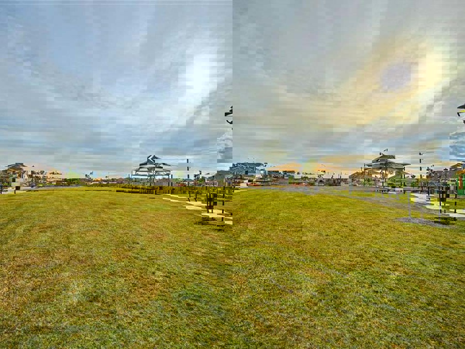 A grassy field with a building in the background.