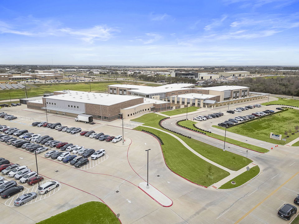 A parking lot with cars and buildings.