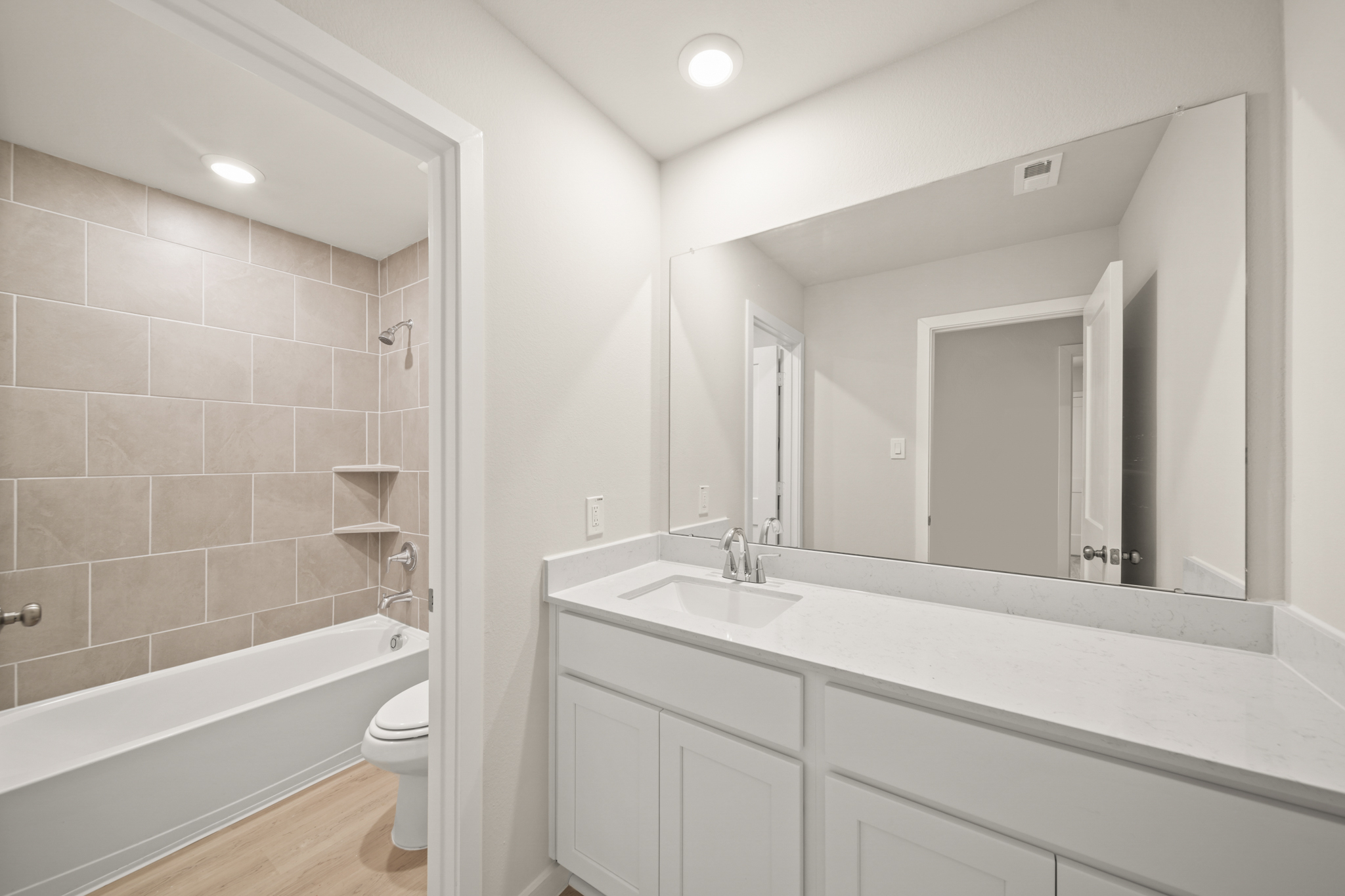 A bathroom with a tub sink and toilet.