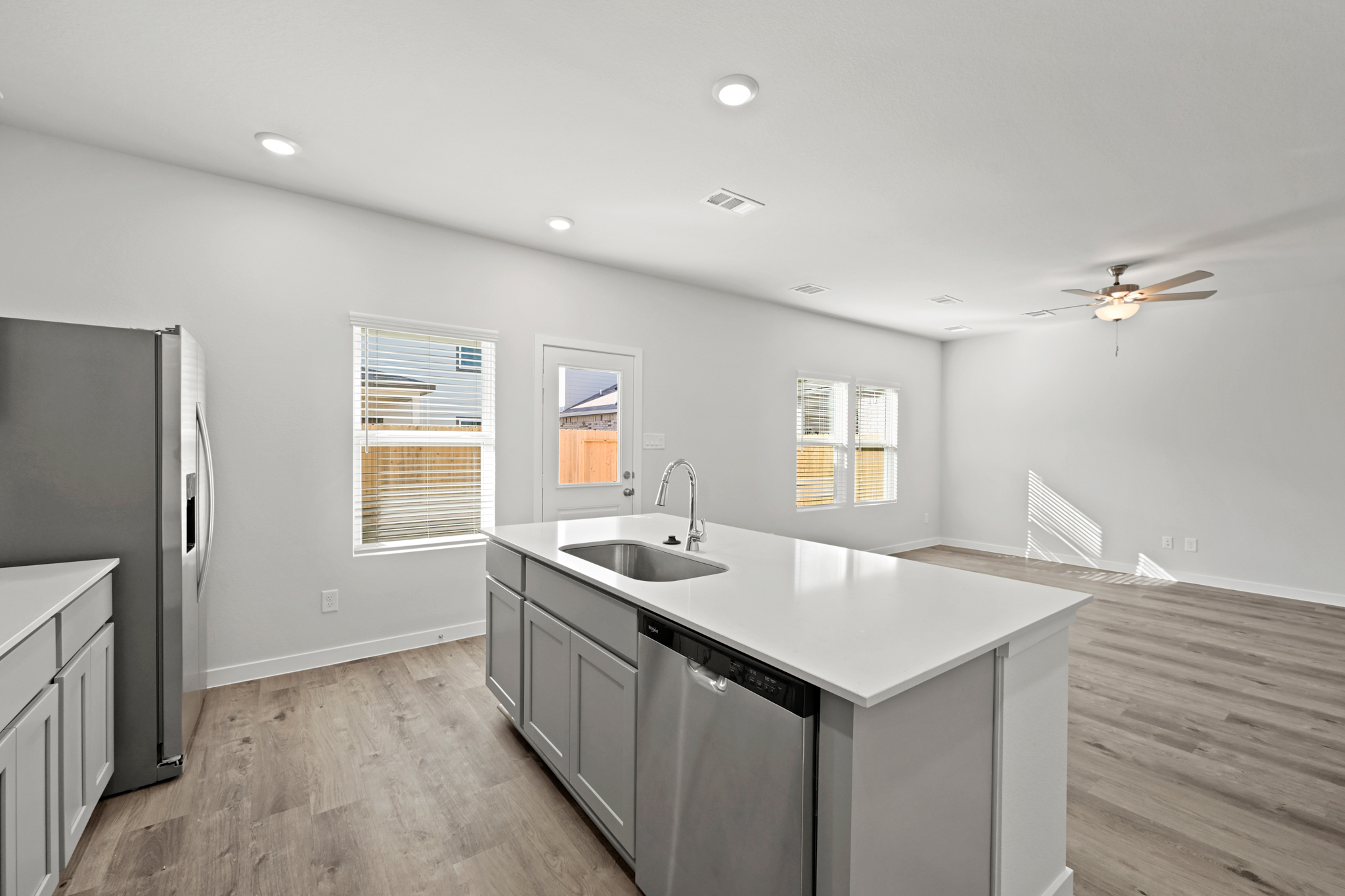 A kitchen with a sink and a refrigerator.