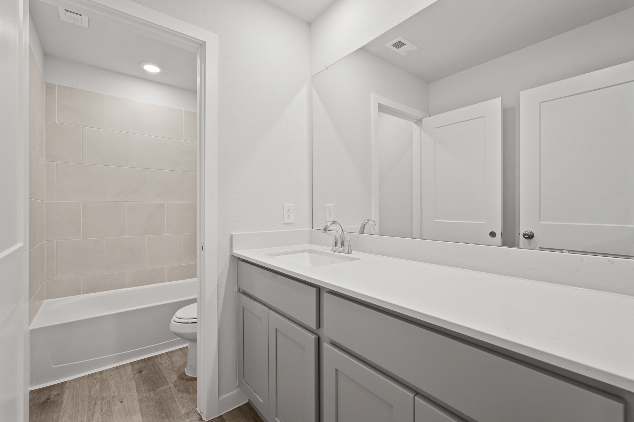 A bathroom with a tub sink and toilet.