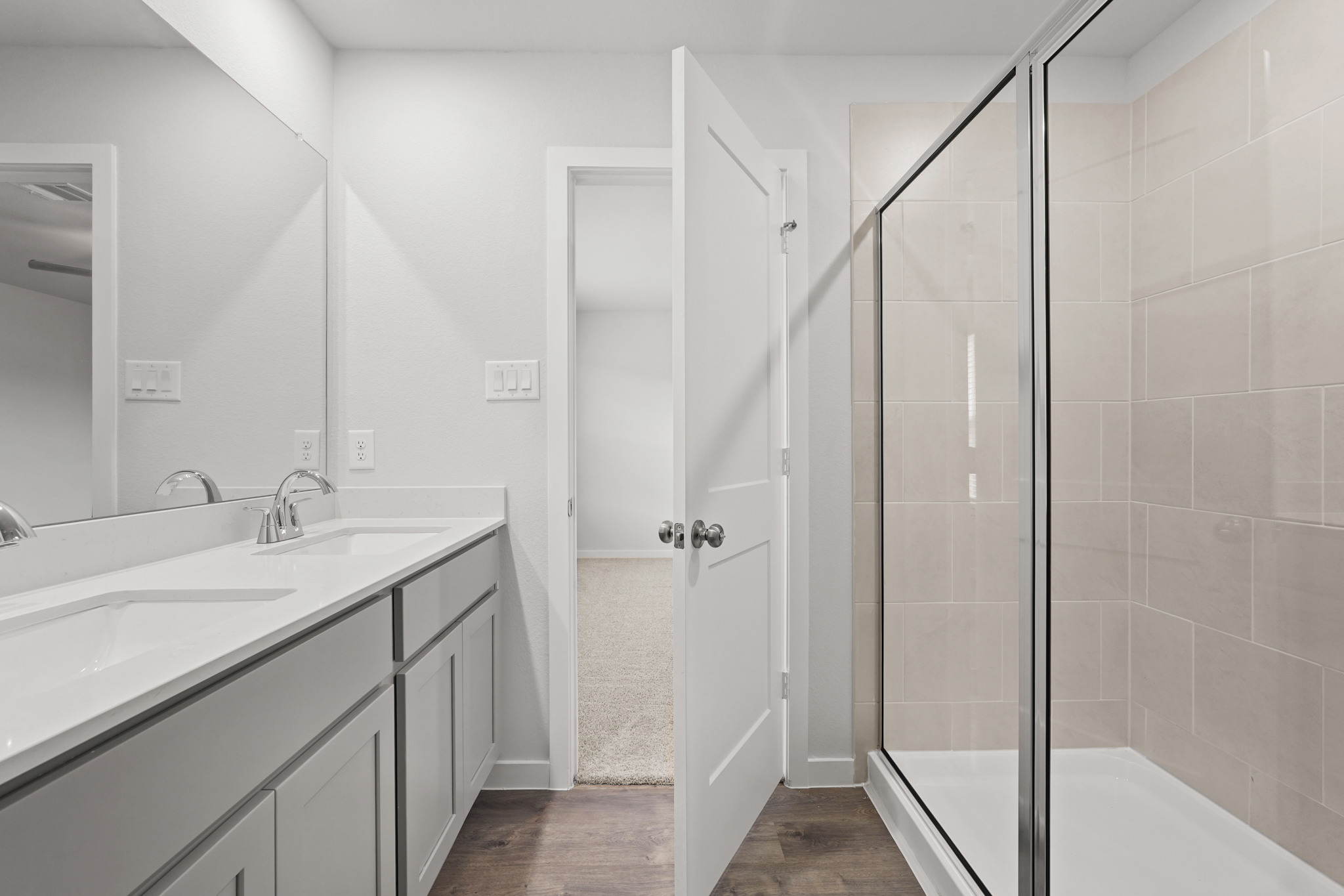 A bathroom with a shower and sink.