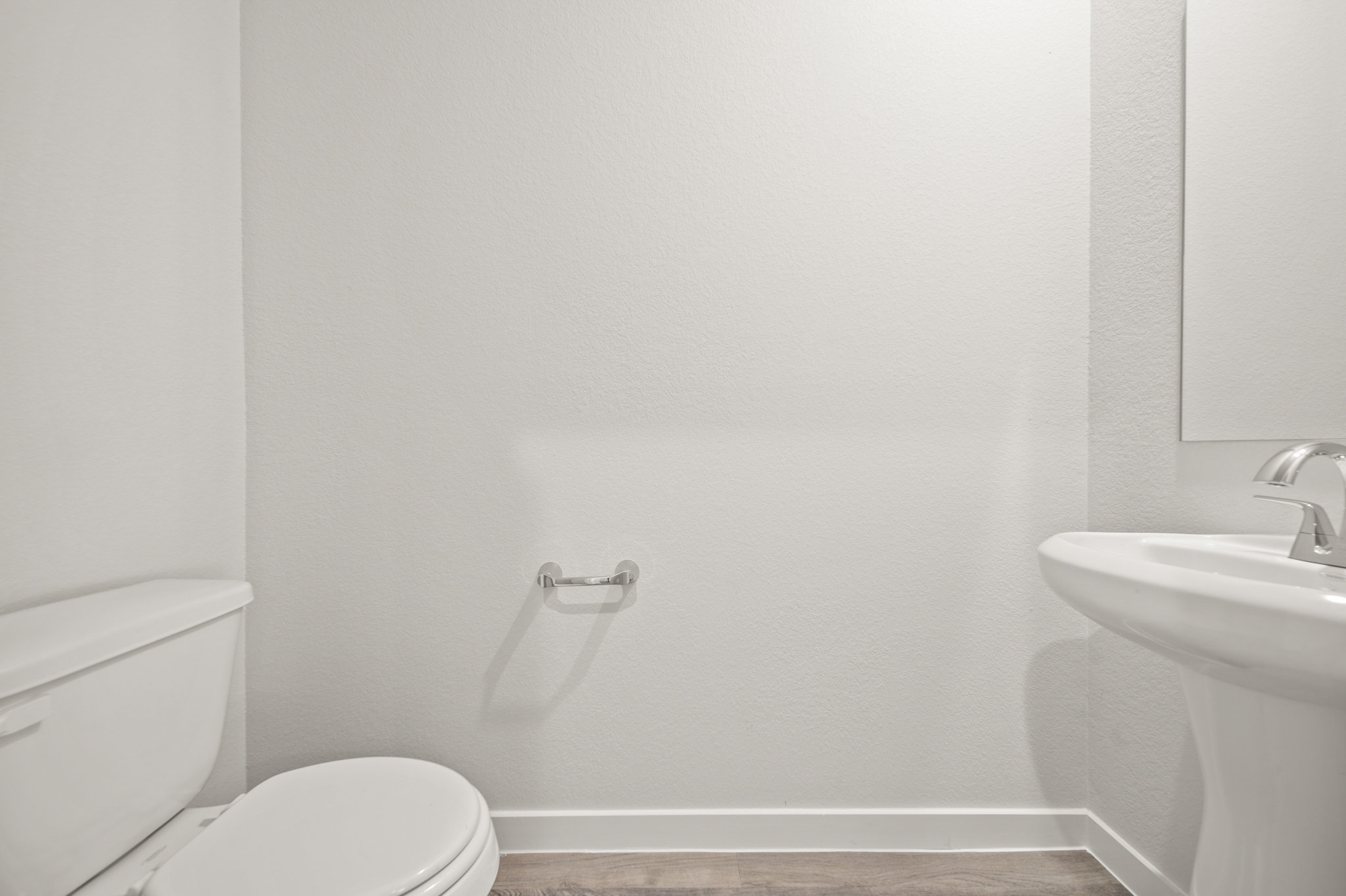 A bathroom with a toilet and sink.