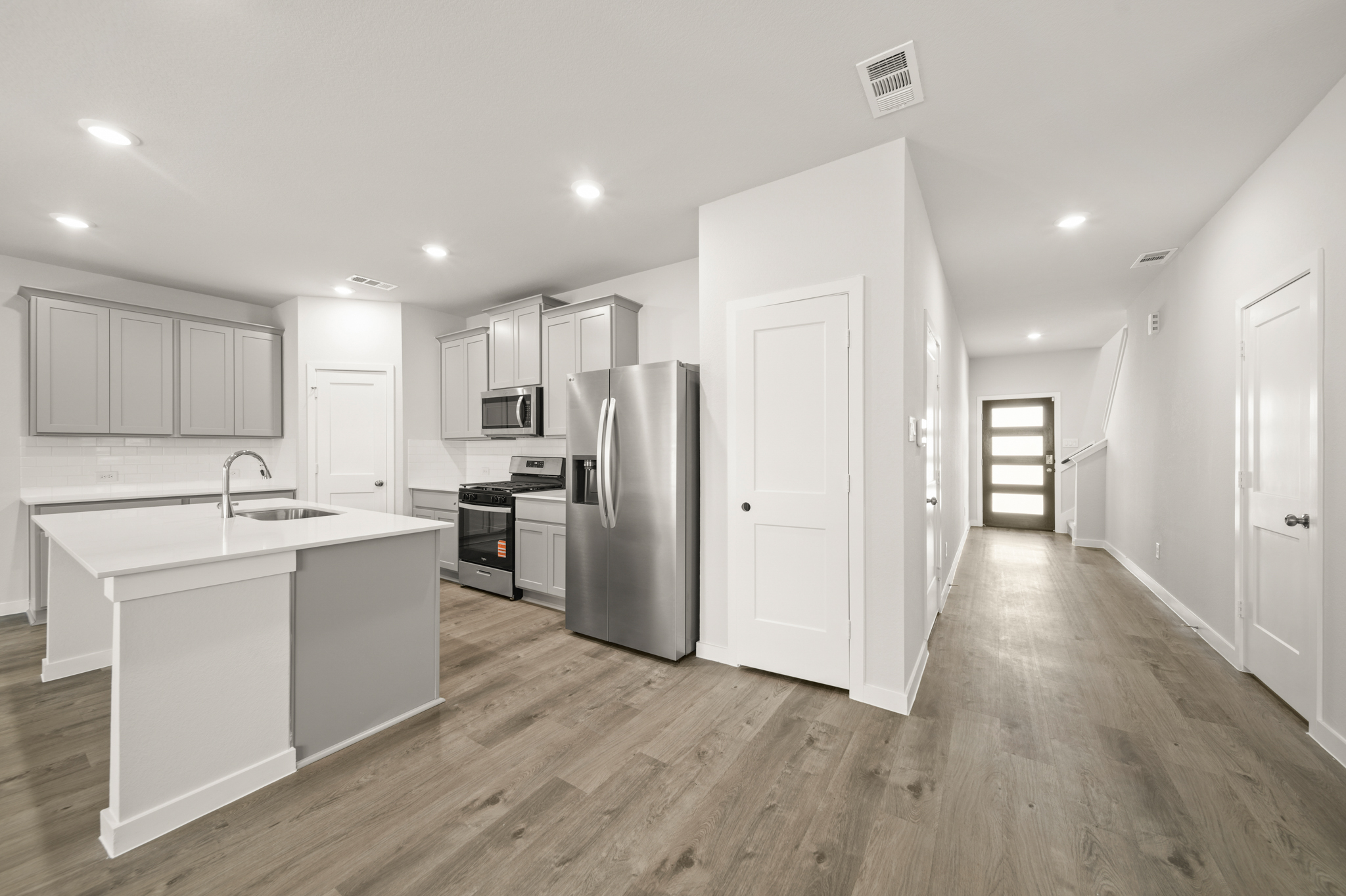 A kitchen with white cabinets.