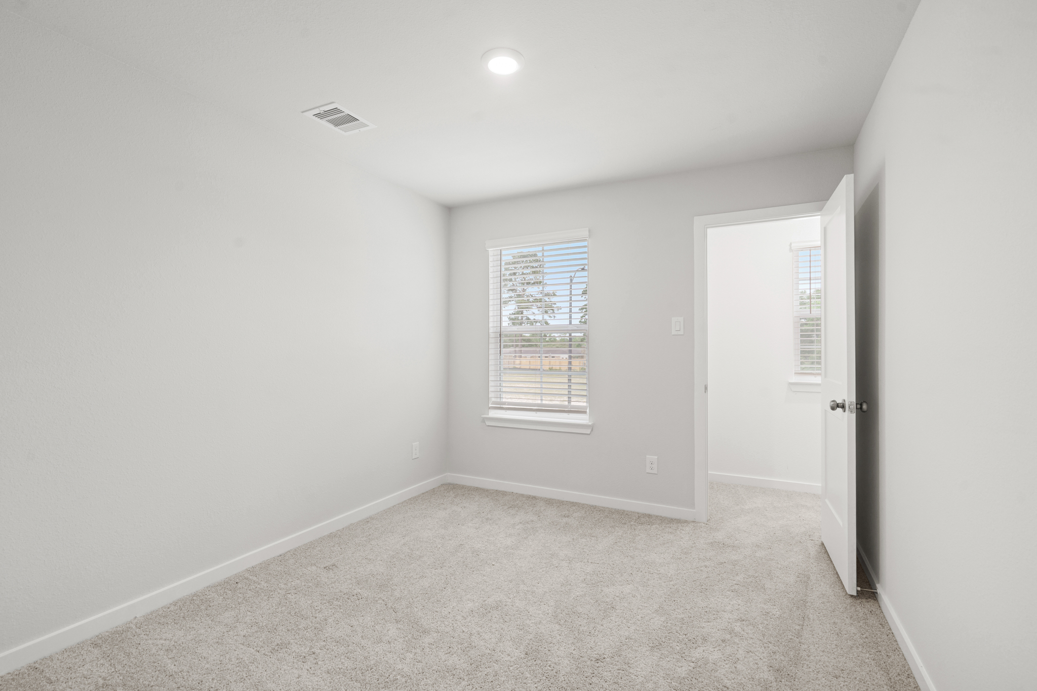 A hallway with a door and a window.