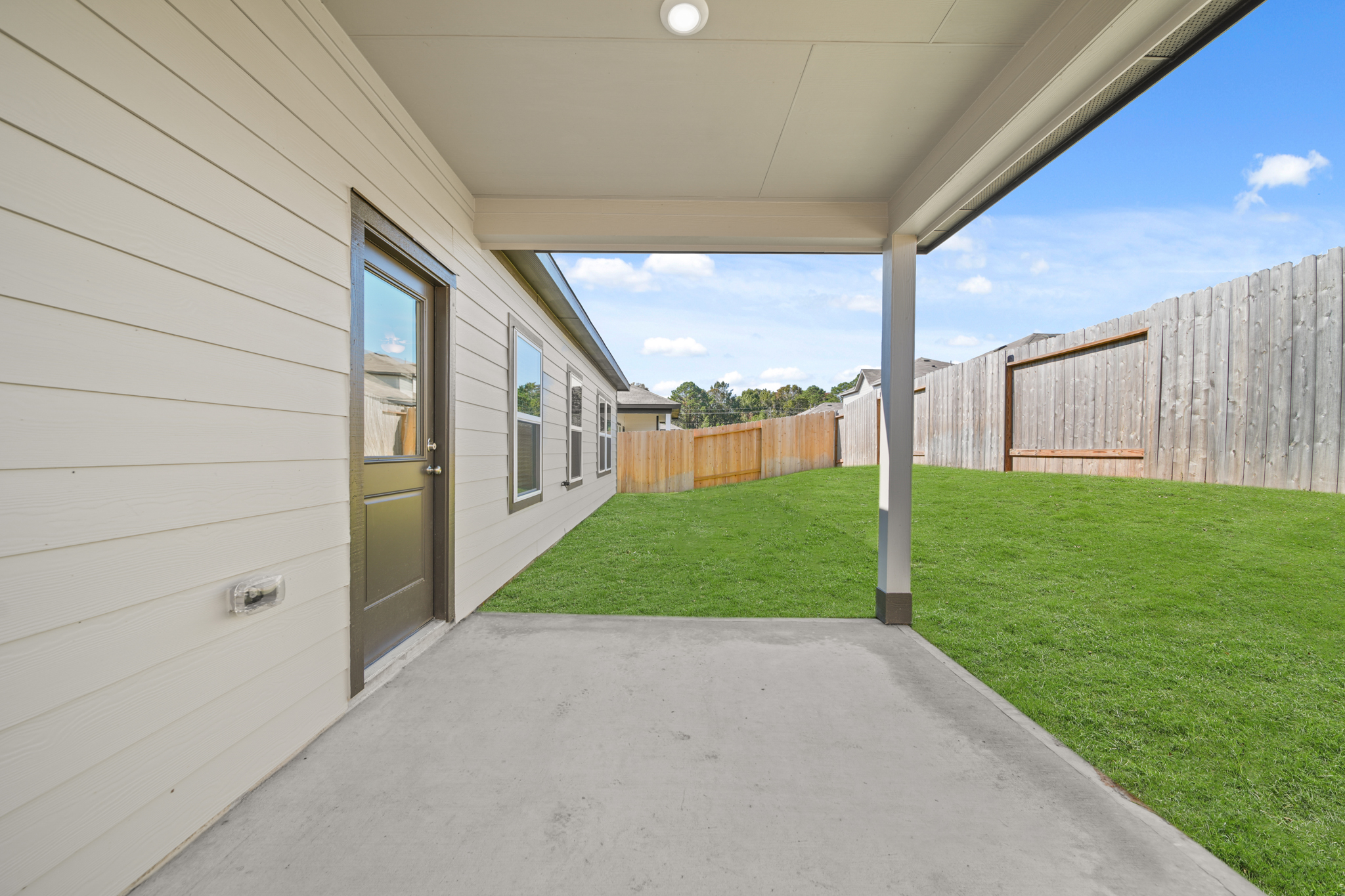 A house with a fence and grass.