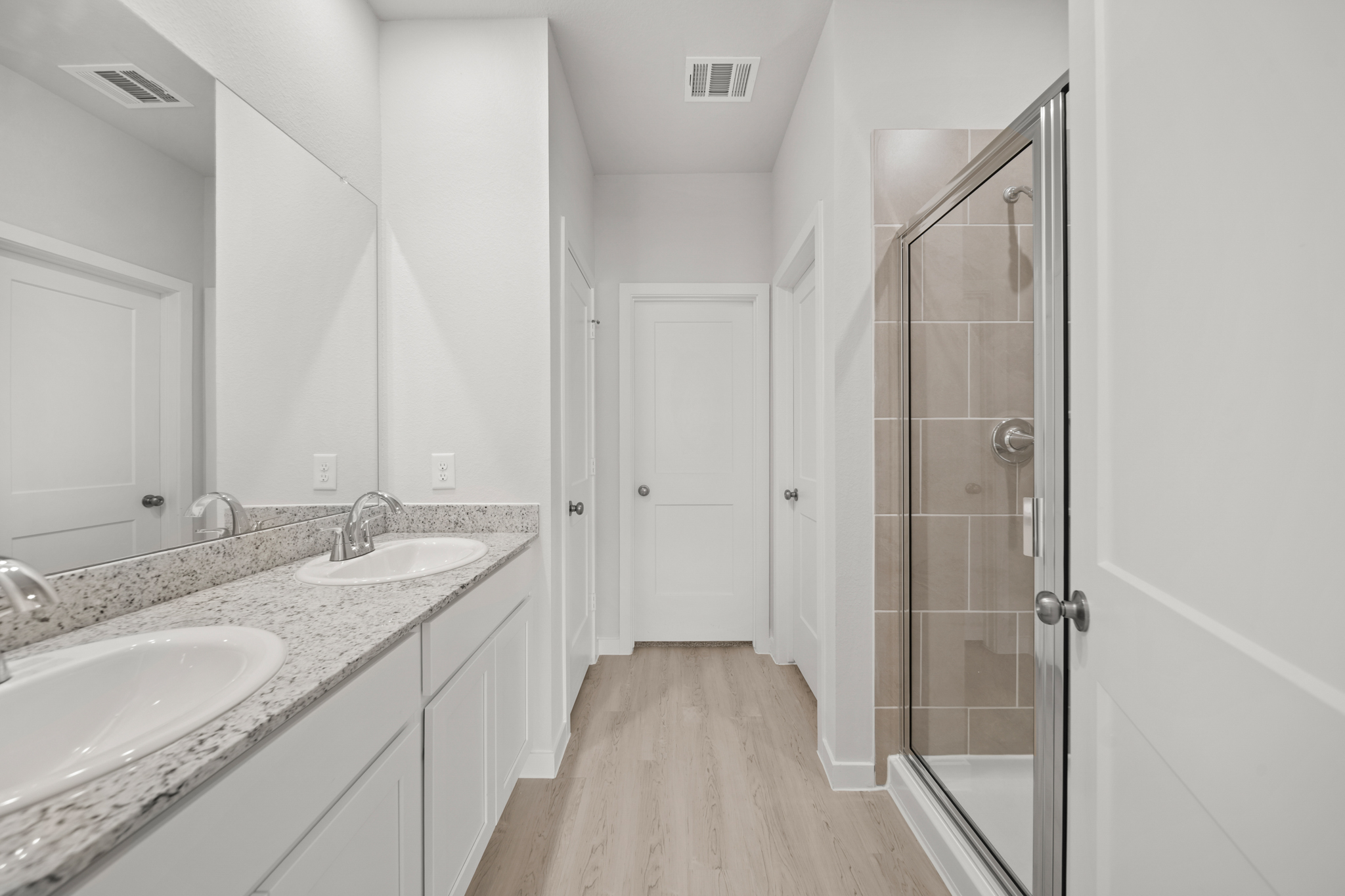 A bathroom with a sink and a shower.