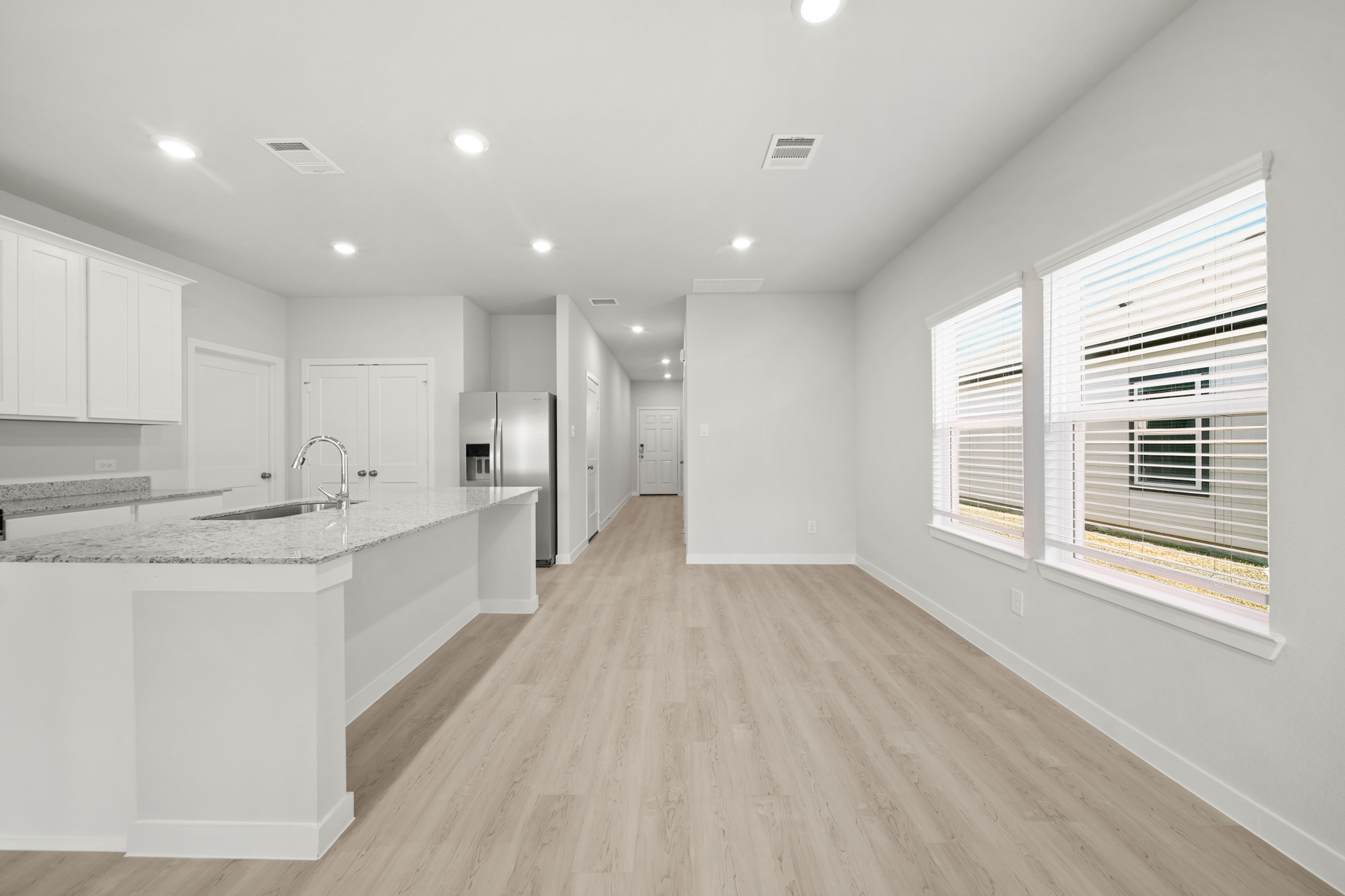 A kitchen with white cabinets.