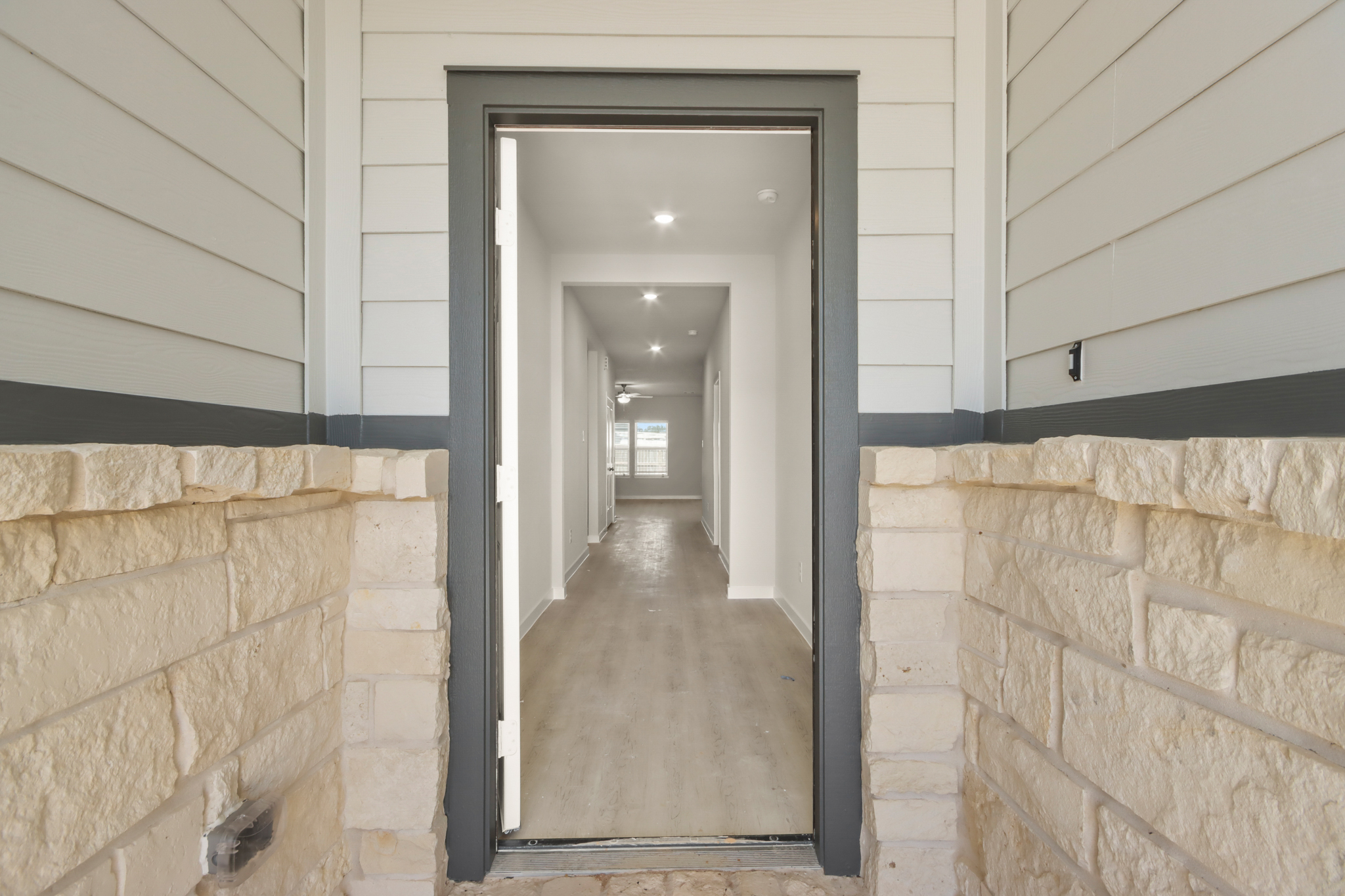 A hallway with a stone wall.