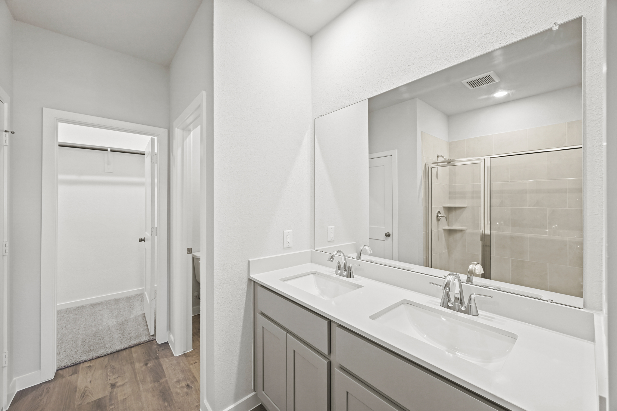 A bathroom with a large mirror.