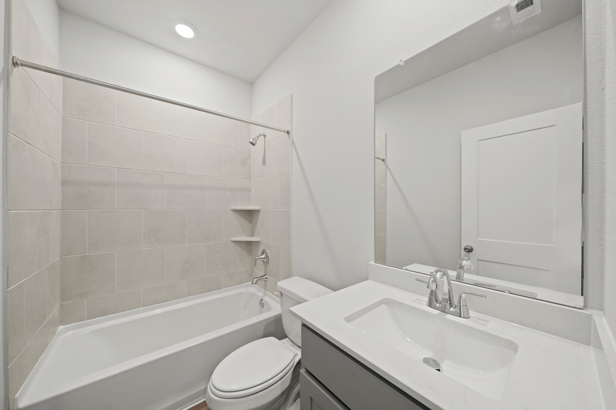A bathroom with a tub sink and toilet.