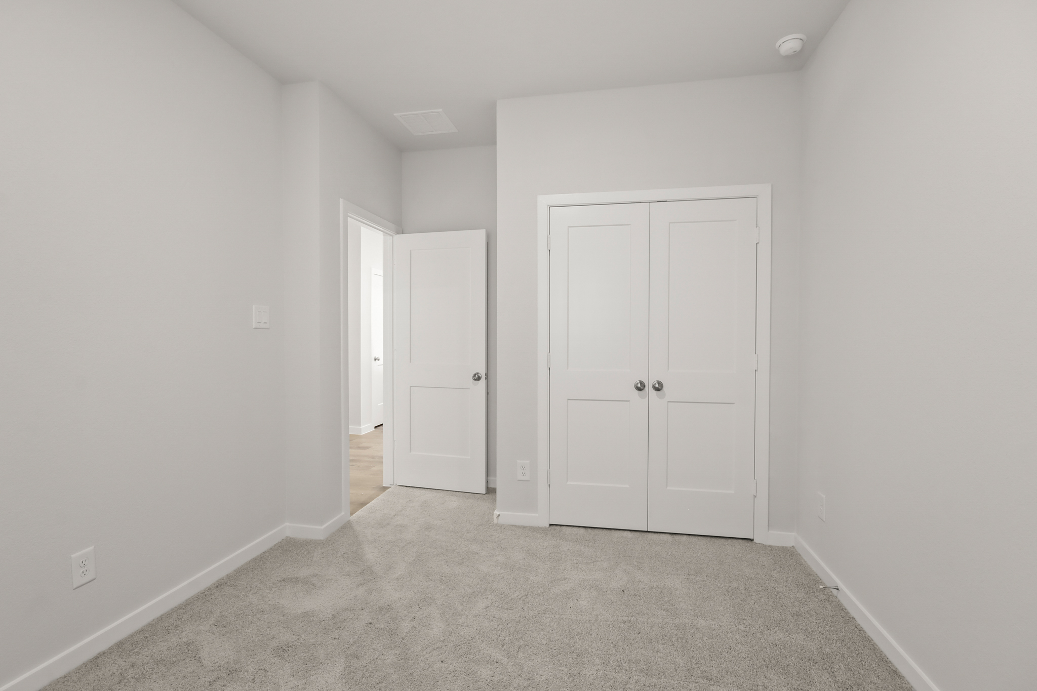 A hallway with white doors.