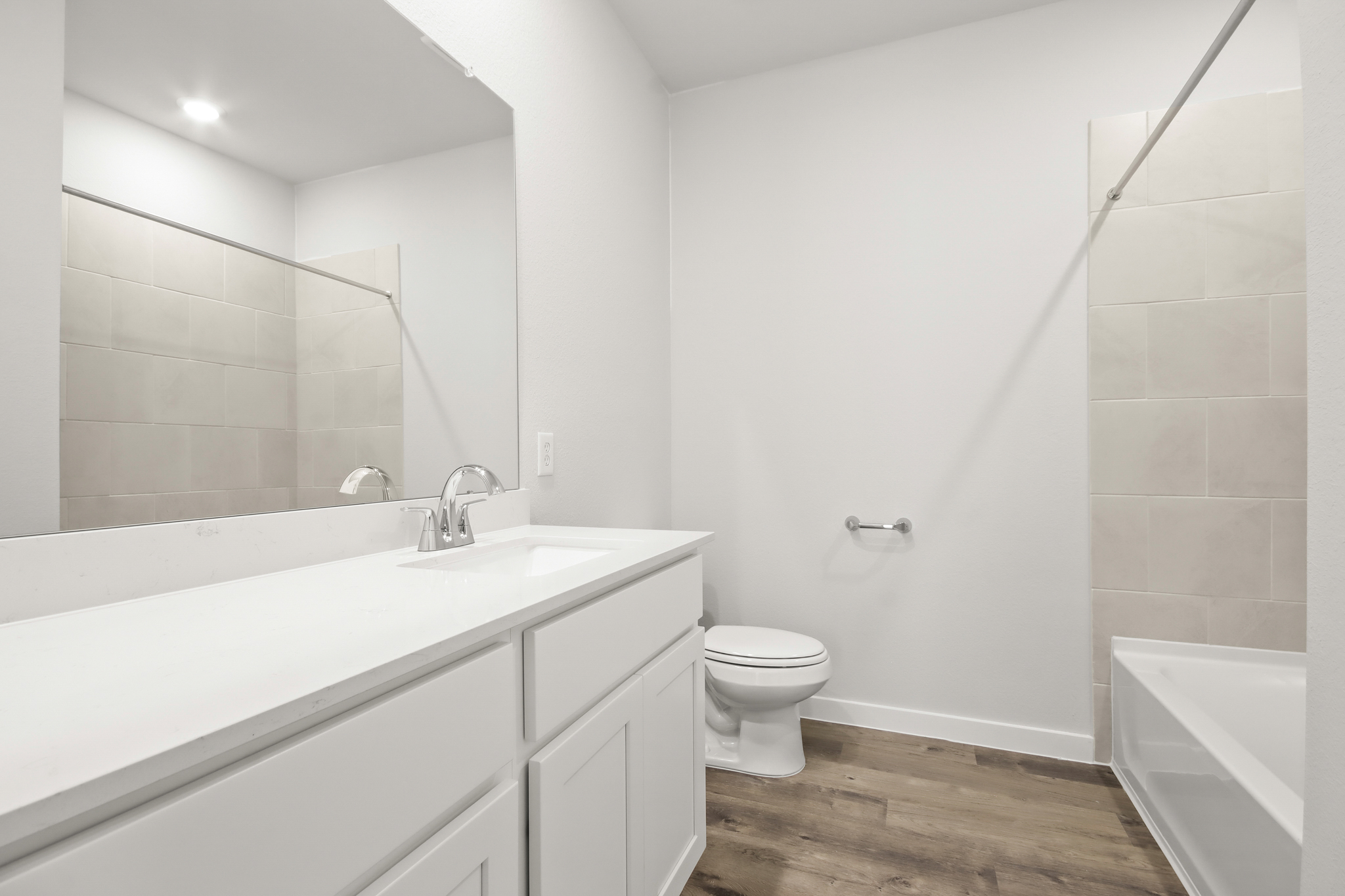 A bathroom with a tub toilet and sink.