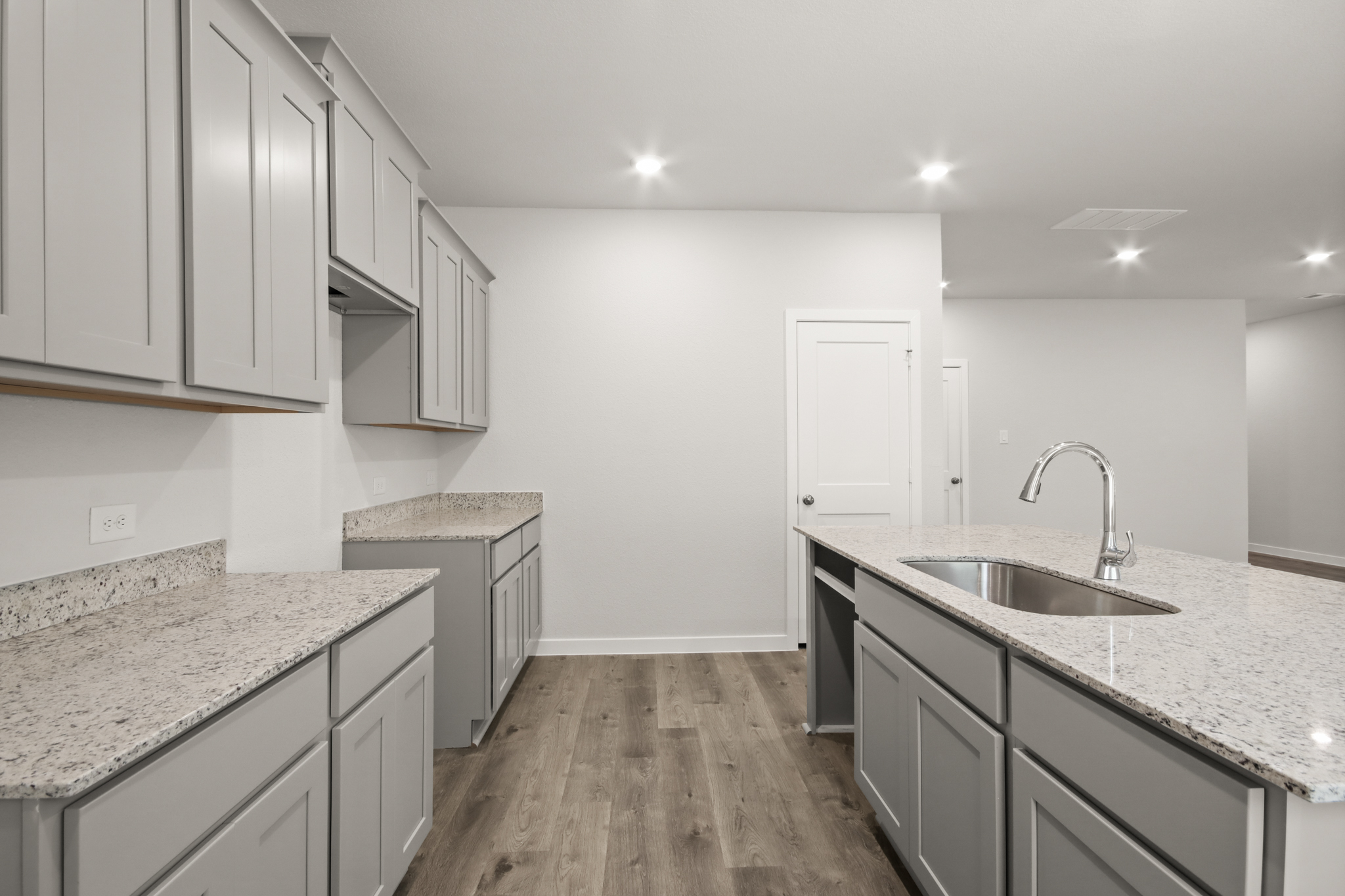 A kitchen with white cabinets.