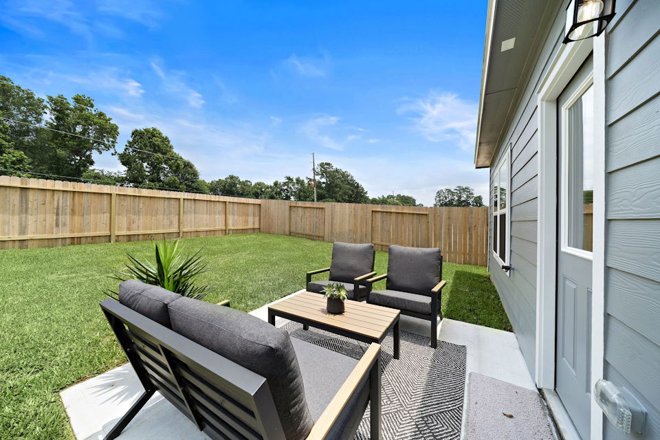 A patio with a table and chairs.