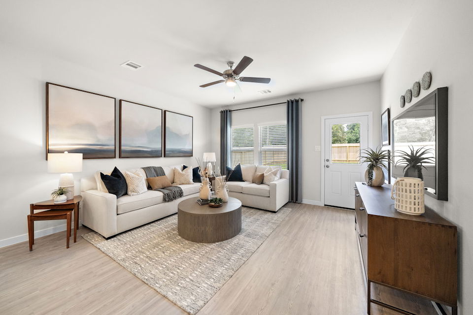 A living room with a large rug.