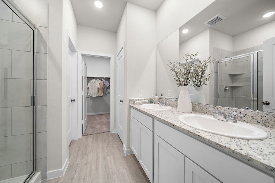 A bathroom with a large mirror.