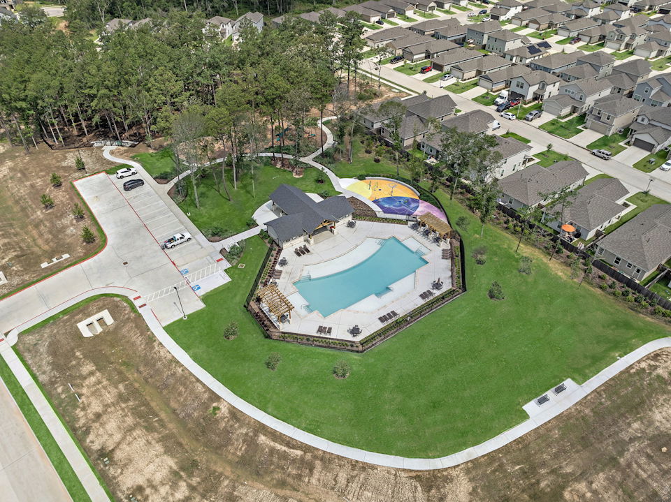 A large building with a green field.