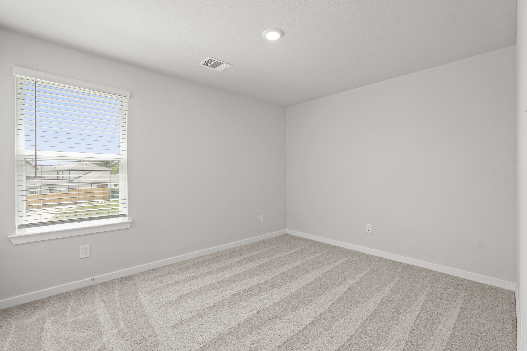 A room with a rug and a window.