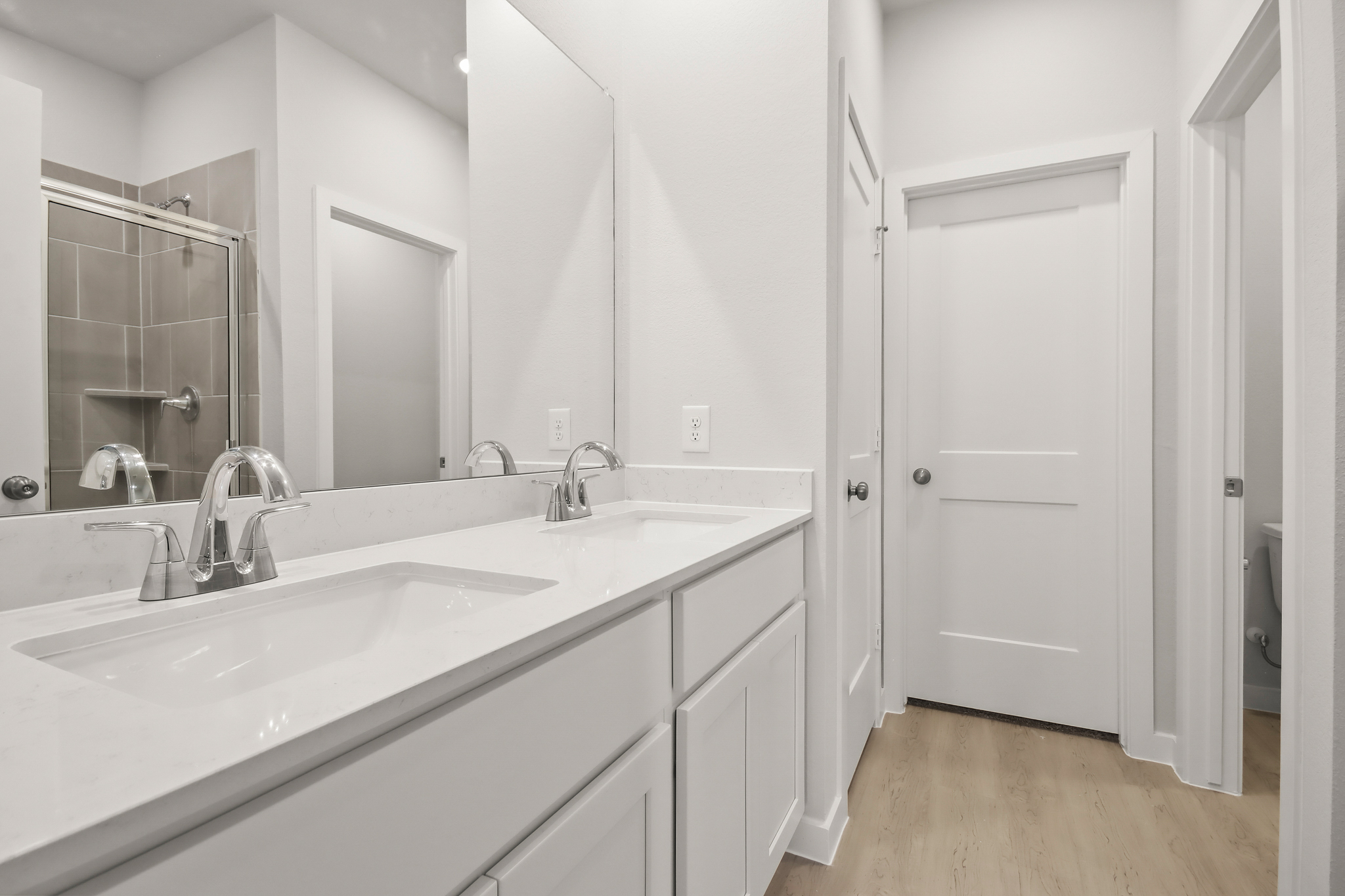 A bathroom with white cabinets.