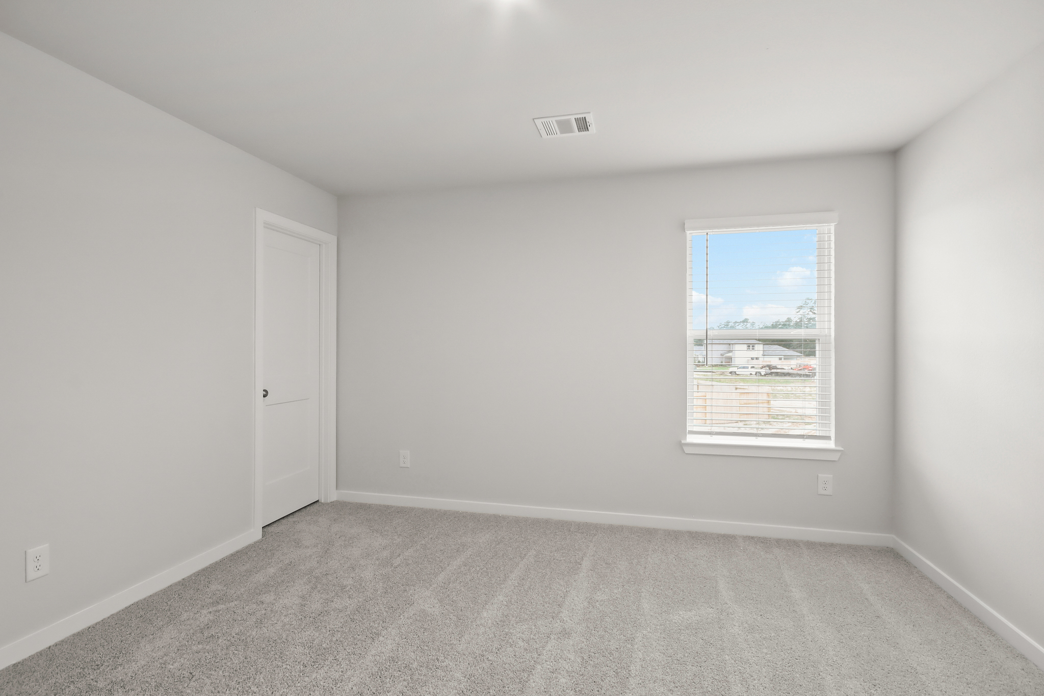 A room with a window and a door.
