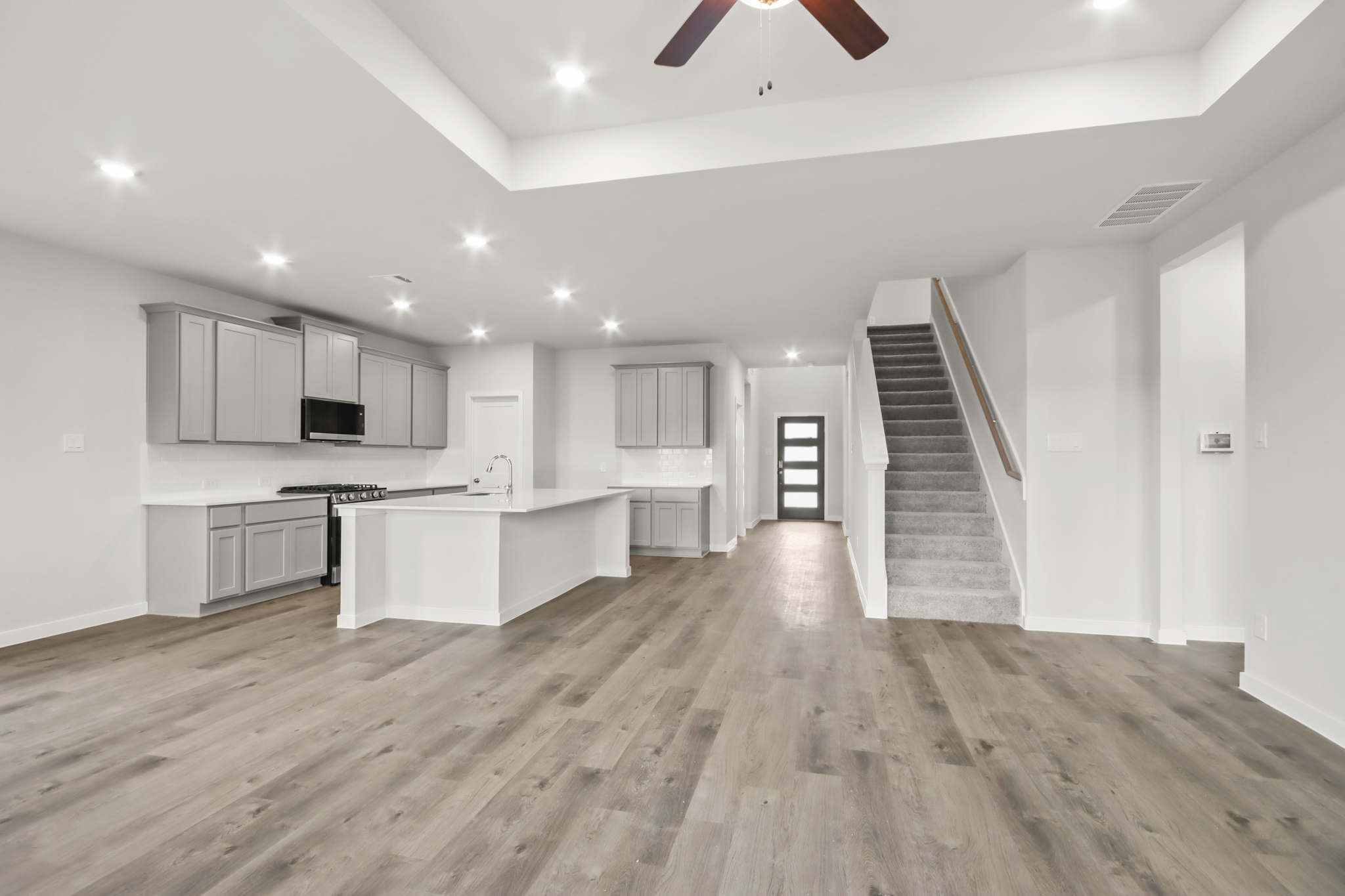 A large kitchen with white cabinets.