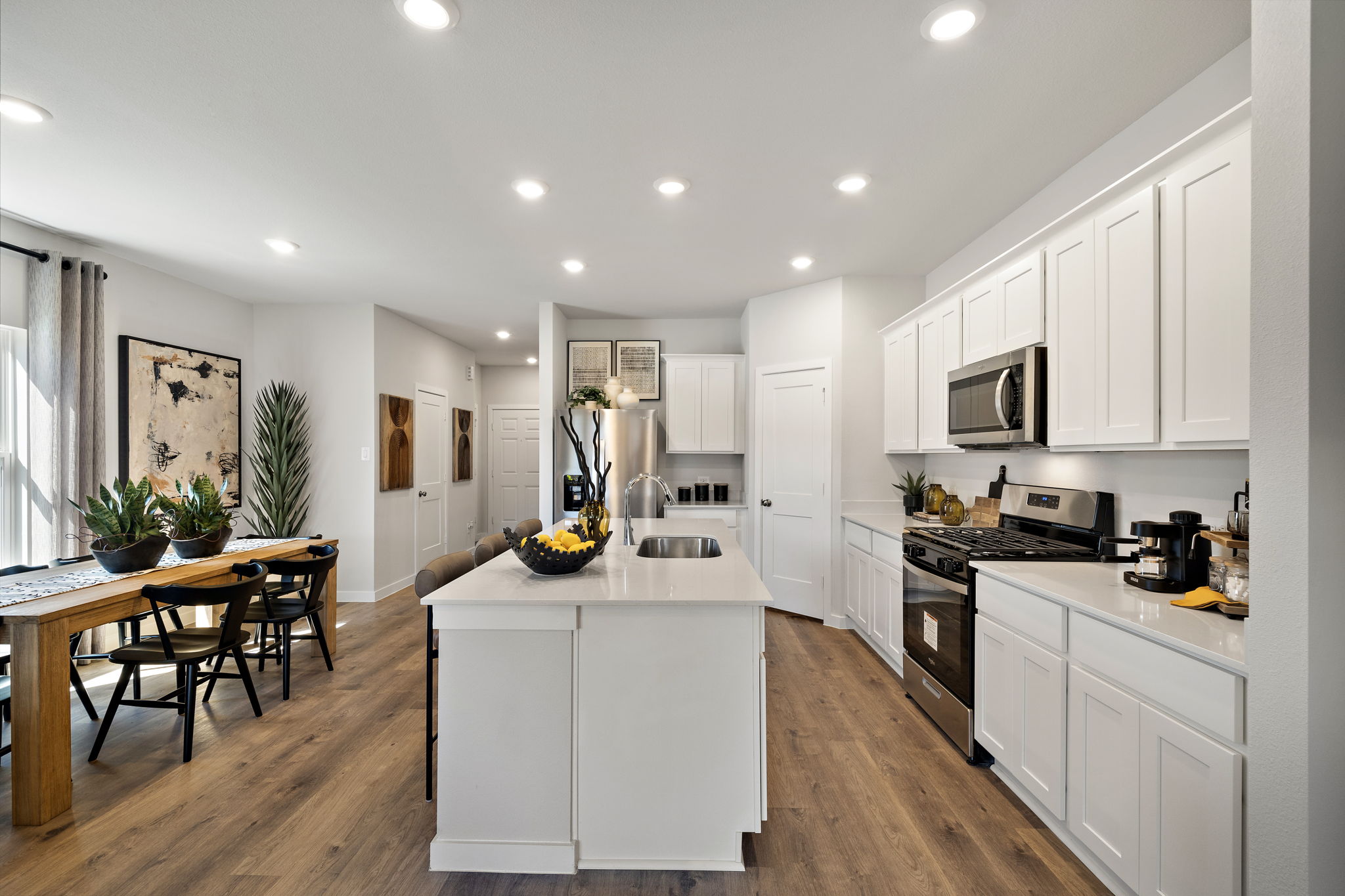 A kitchen with white cabinets.