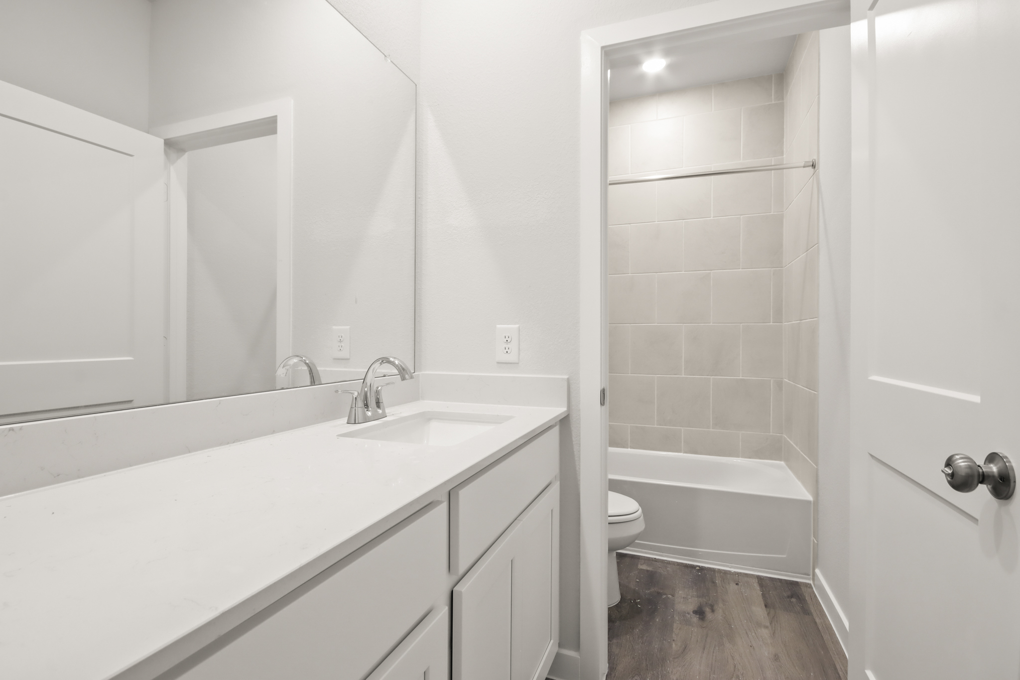 A bathroom with a tub sink and toilet.