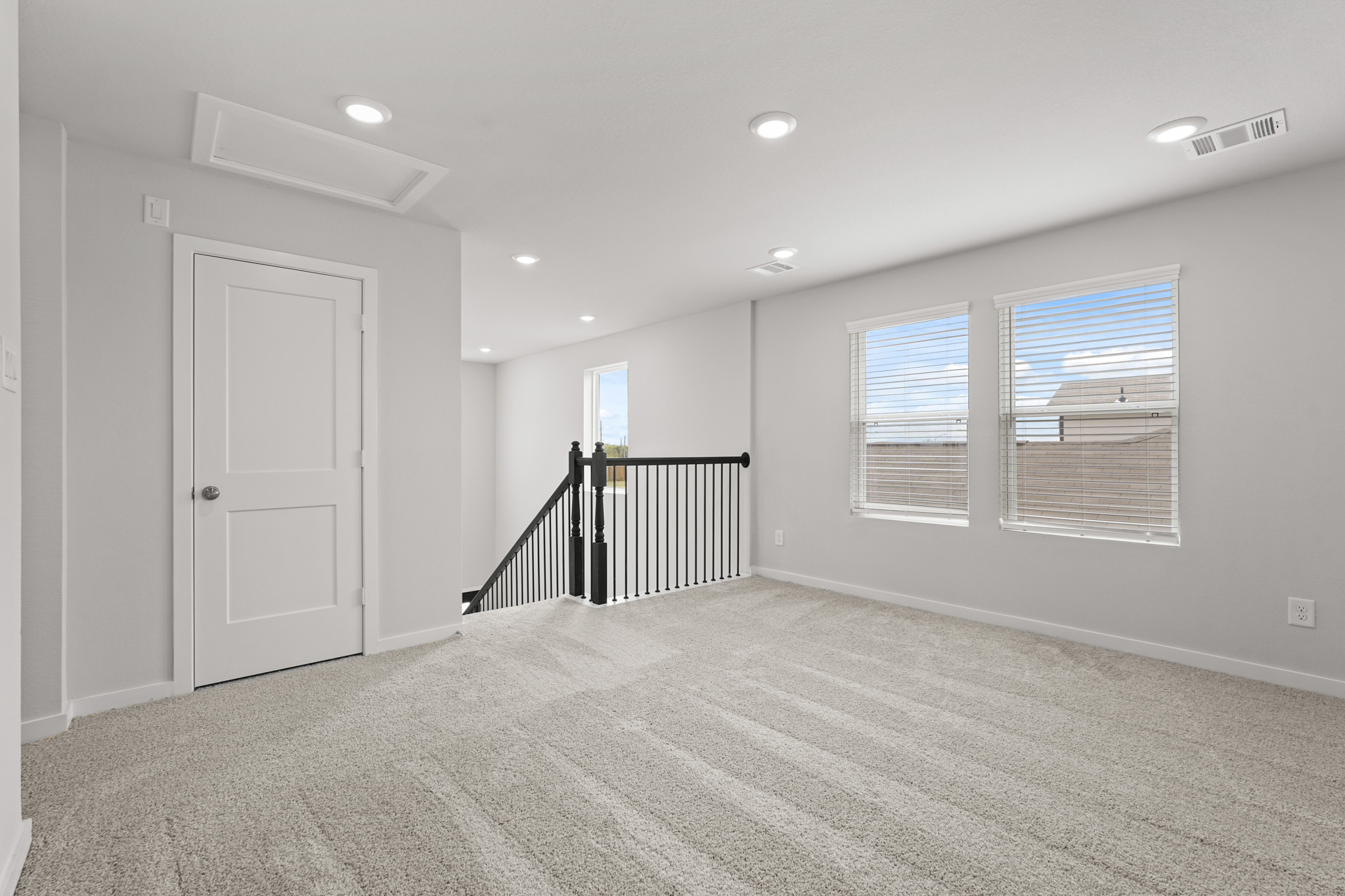 A room with white walls and a staircase.