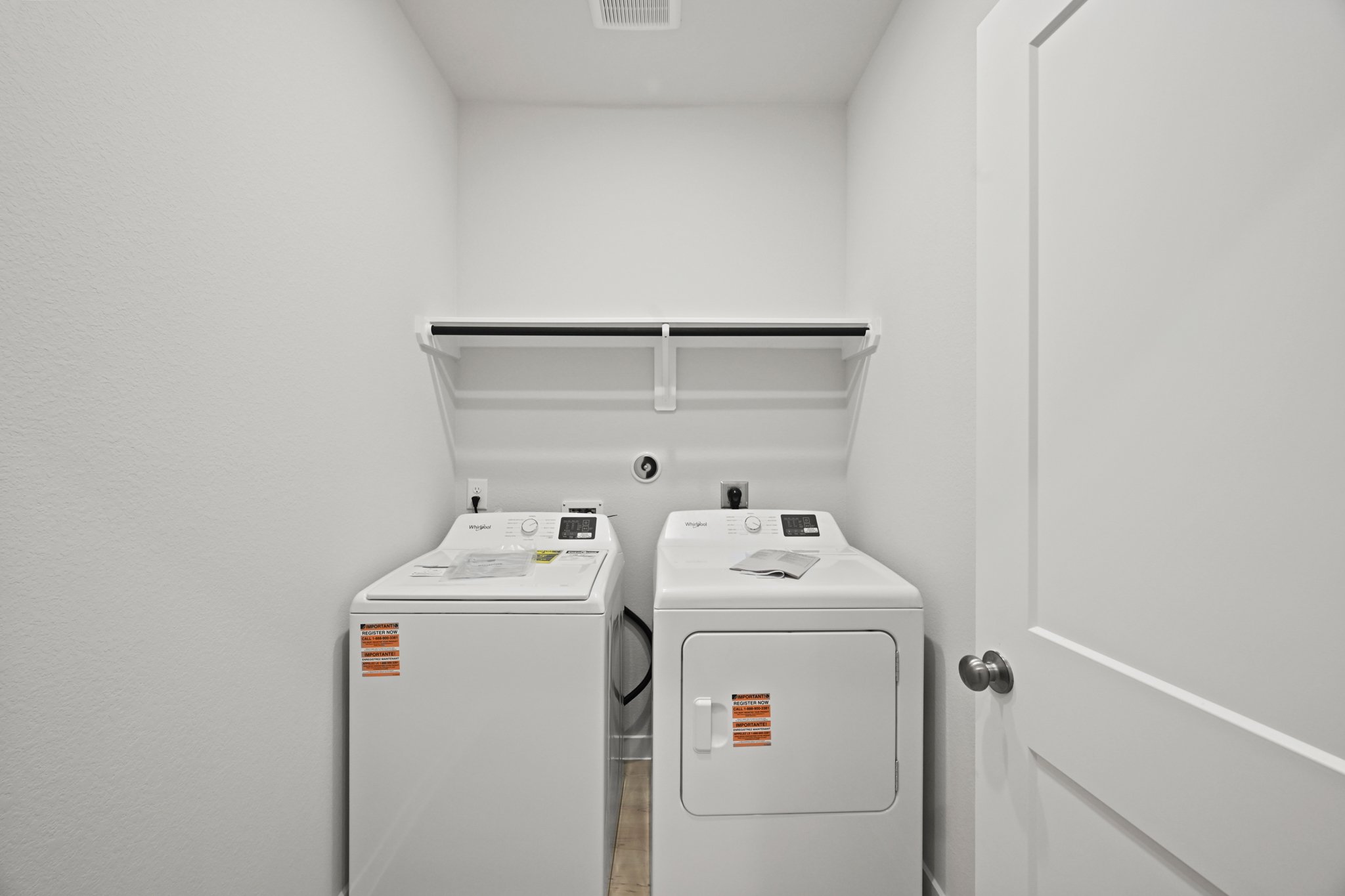 A white room with a white wall and a white door.