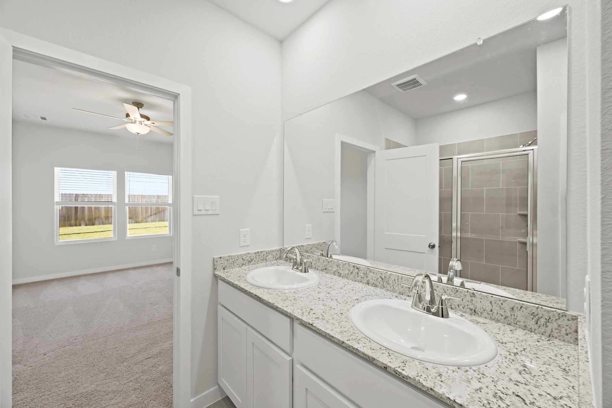 A bathroom with a large mirror.