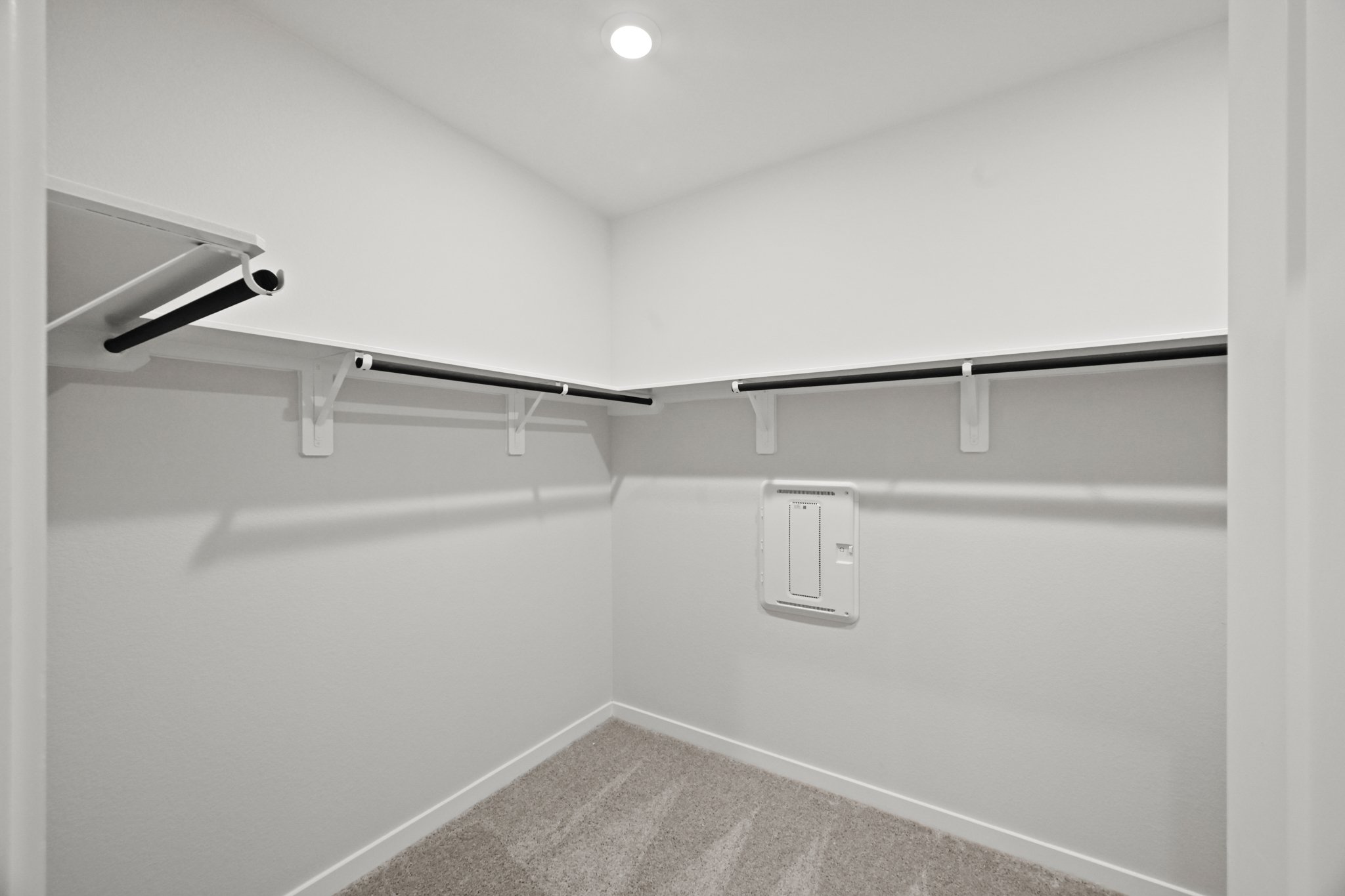 A white wall with a light on it.